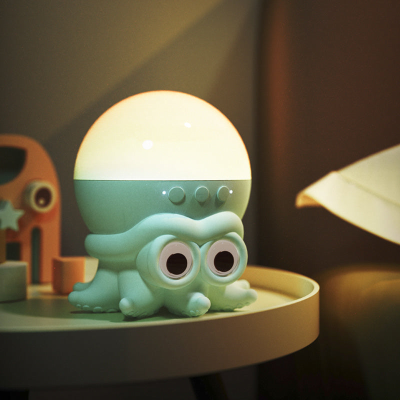 Green octopus-shaped night light on a table with a warm glow